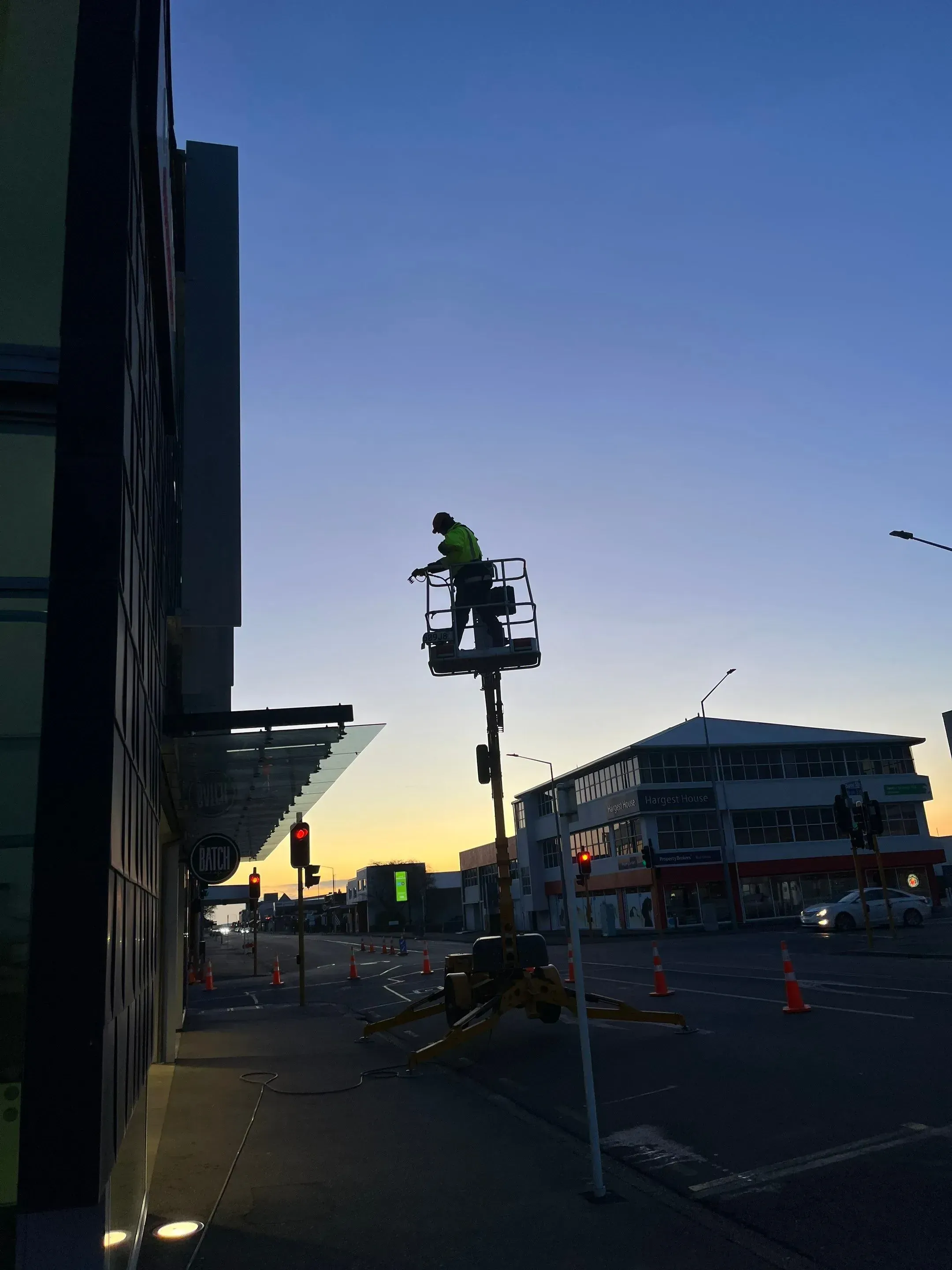 Worker from Southern Gutters cleaning commercial building.